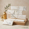 White and gold veined calacatta gold marble 3x6 deep-beveled polished honed tiles stacked display