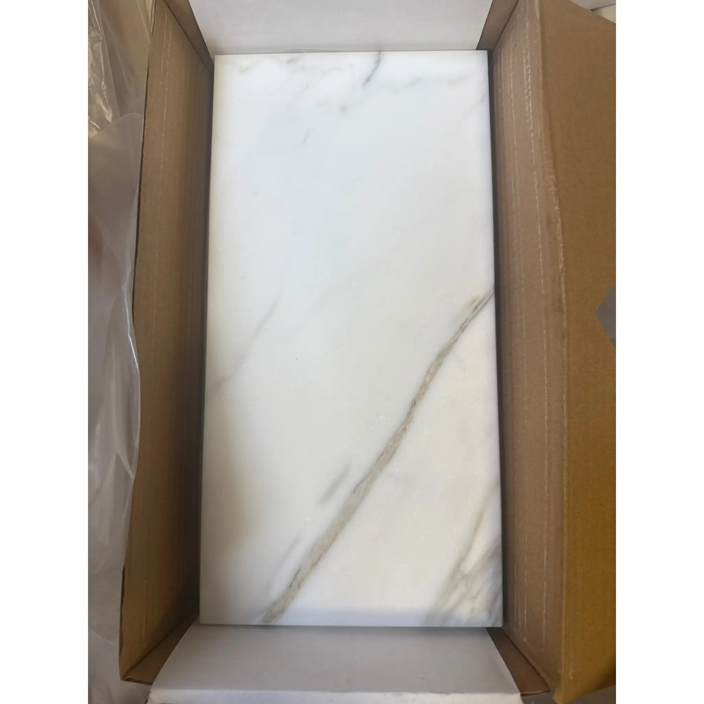 White marble-patterned tile from Calacatta Gold Marble 6X12 collection, polished or honed finish