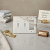 Calacatta Gold marble double toggle rocker switch wall plate in white with gray veining and gold-toned finish
