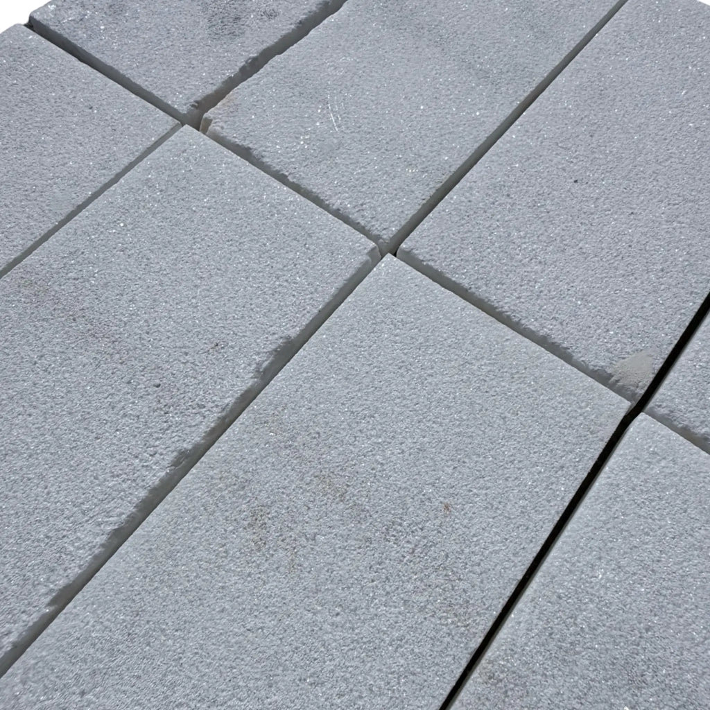 Gray concrete pavers featuring Calacatta Gold Marble in a sand blasted finish