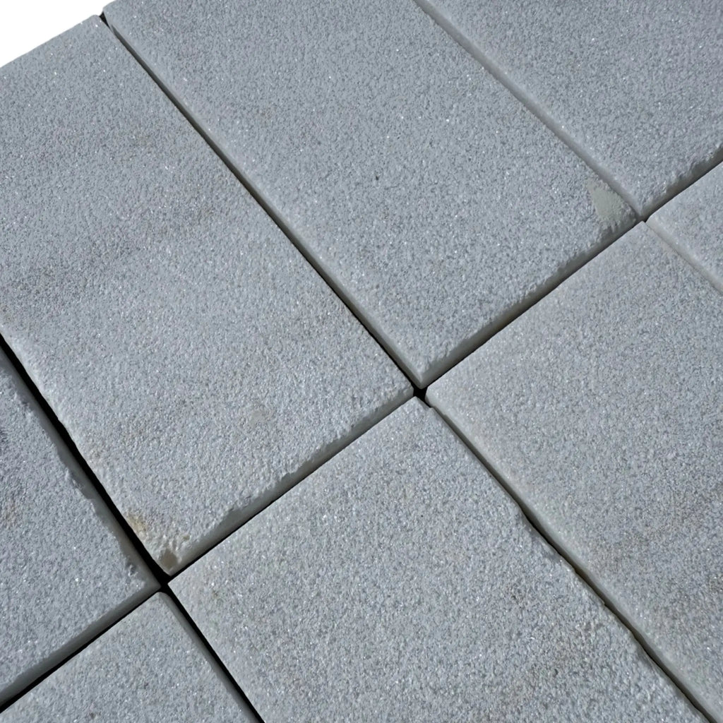 Gray rectangular paving stones of Calacatta Gold Marble in sand blasted finish