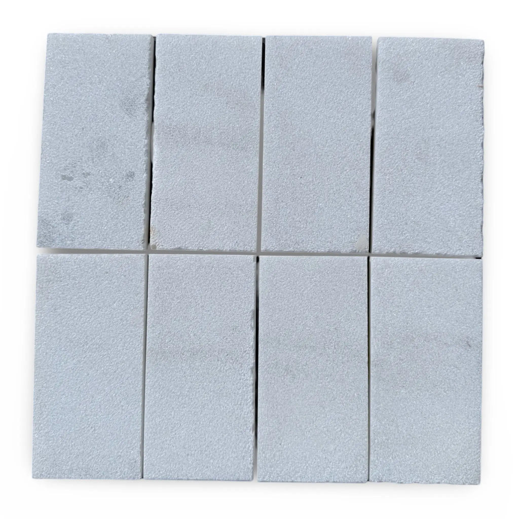 Rectangular gray stone tiles of Calacatta Gold Marble with a sand-blasted finish