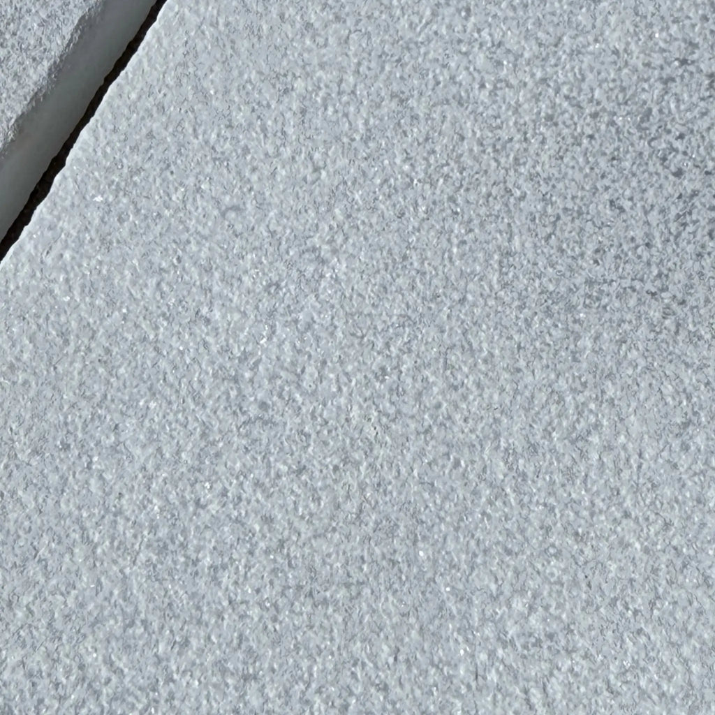 Textured gray stone surface of Calacatta Gold Marble in a sand blasted finish