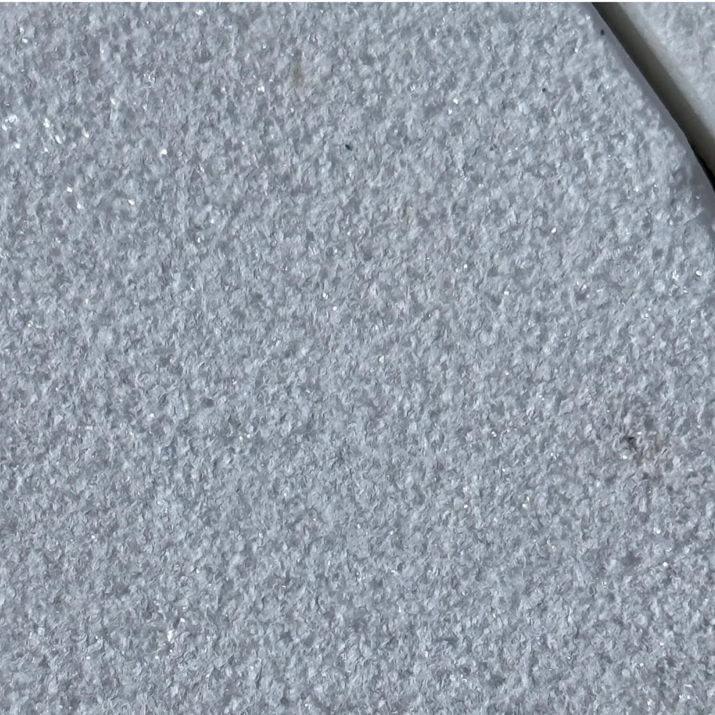 Textured gray tile of Calacatta Gold Marble in a sand blasted finish