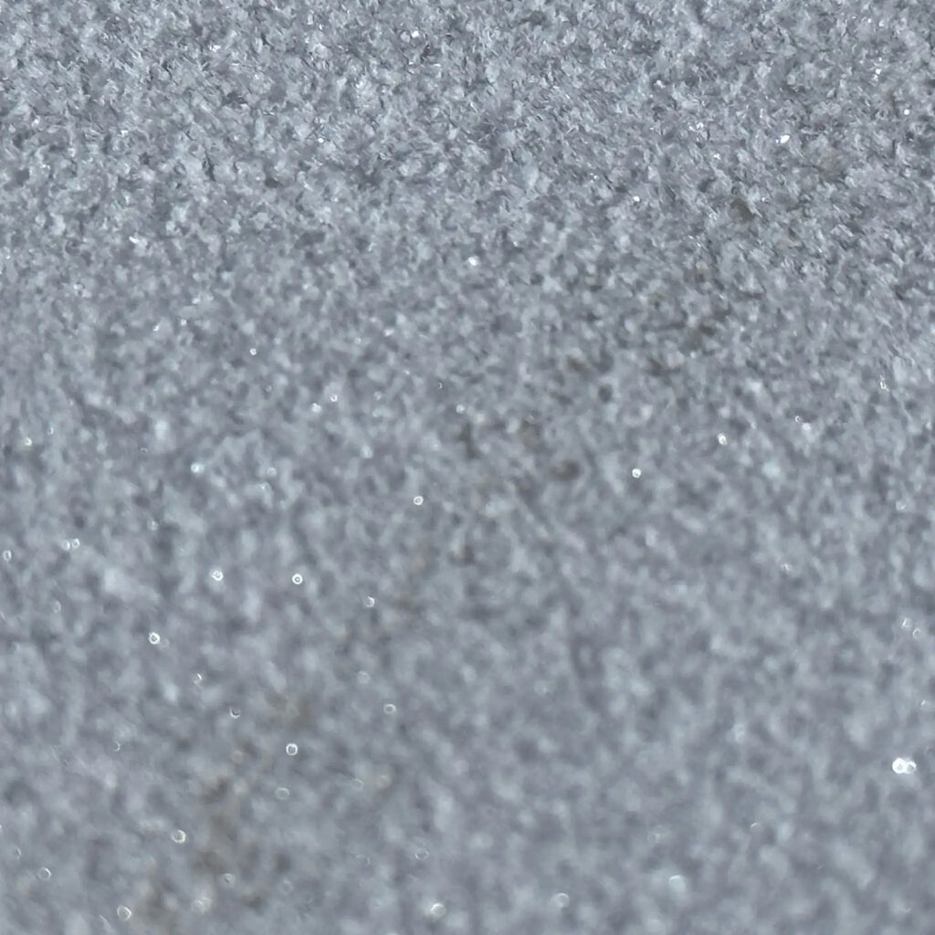 Sparkling textured silvery surface of Calacatta Gold Marble Sand Blasted finish