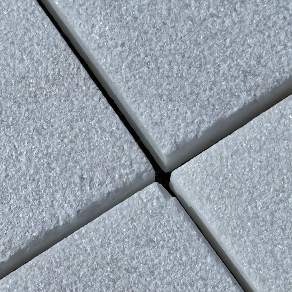 Textured white stone tiles in Calacatta Gold Marble with a sand blasted finish