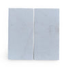 Two light blue rectangular blocks of Calacatta Gold Marble in a sand blasted finish