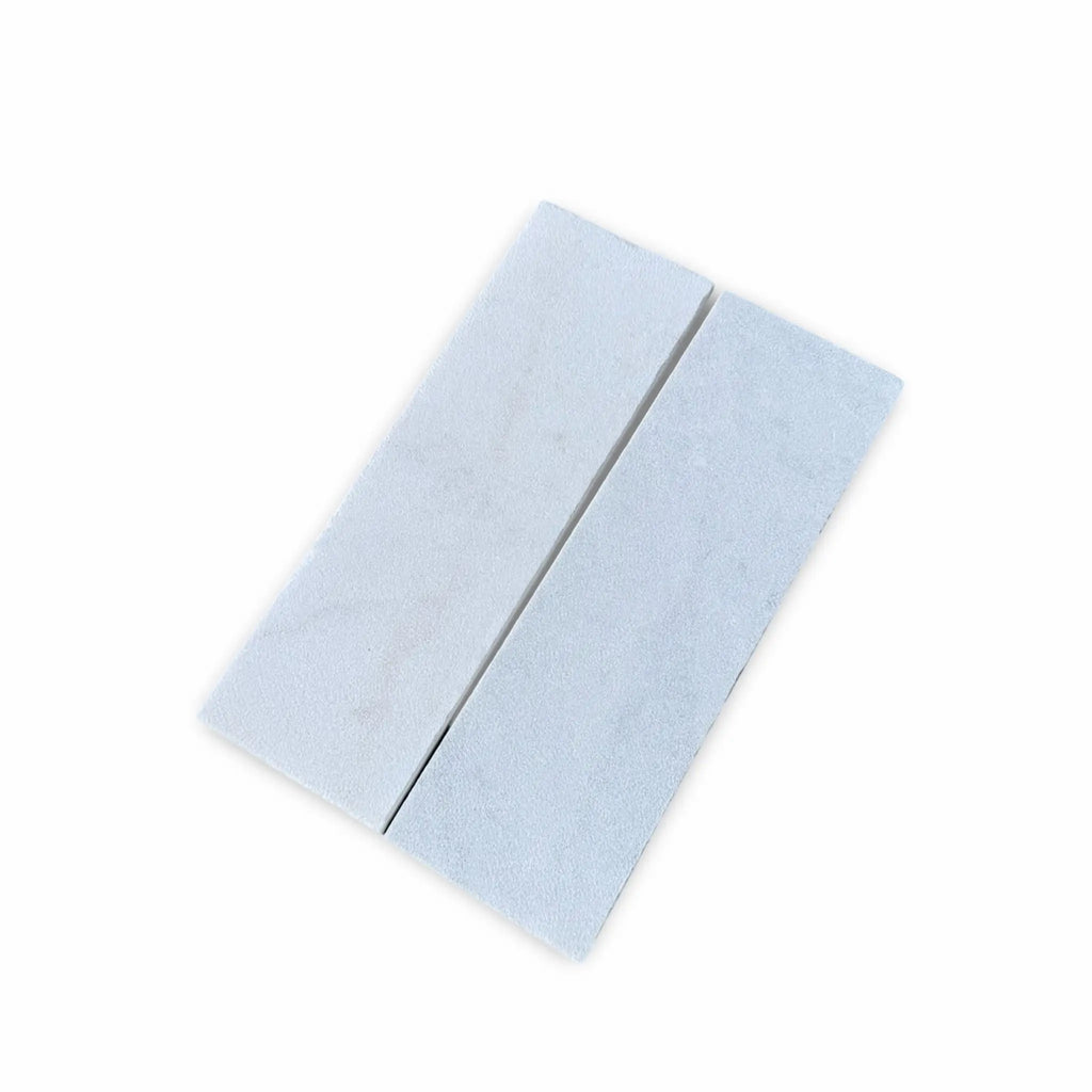Two rectangular white Calacatta Gold marble blocks with a sand blasted finish