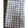 White marble calacatta gold octagon mosaic tile polished with black diamond accents wrapped in clear plastic