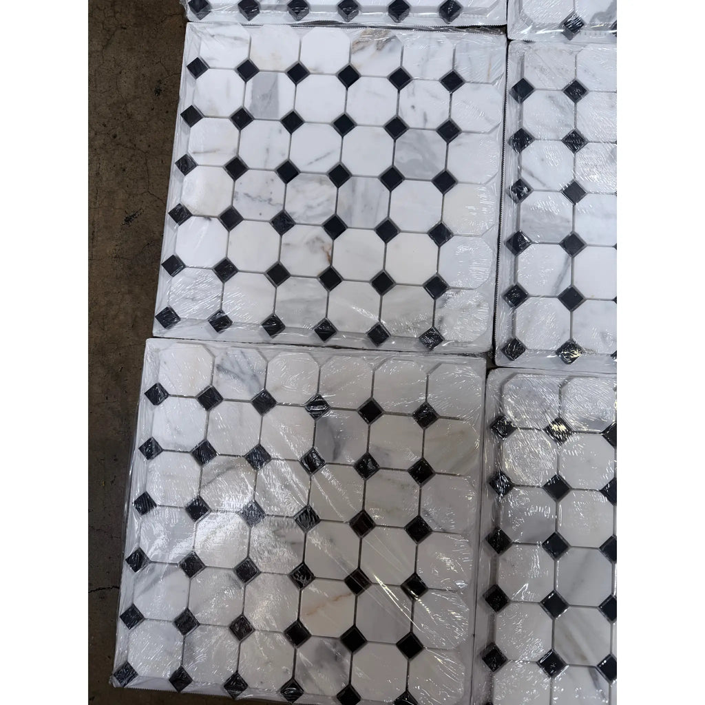 White marble calacatta gold octagon mosaic tile polished with black diamond accents wrapped in clear plastic