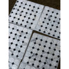 Calacatta gold octagon polished marble tile with white hexagonal tiles and black diamond accents packaged in clear plastic