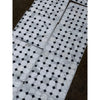 White marble calacatta gold octagon mosaic tile with black diamond accents wrapped in clear plastic packaging