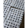 White marble hexagonal calacatta gold octagon mosaic tile with black diamond accents packaged in clear plastic