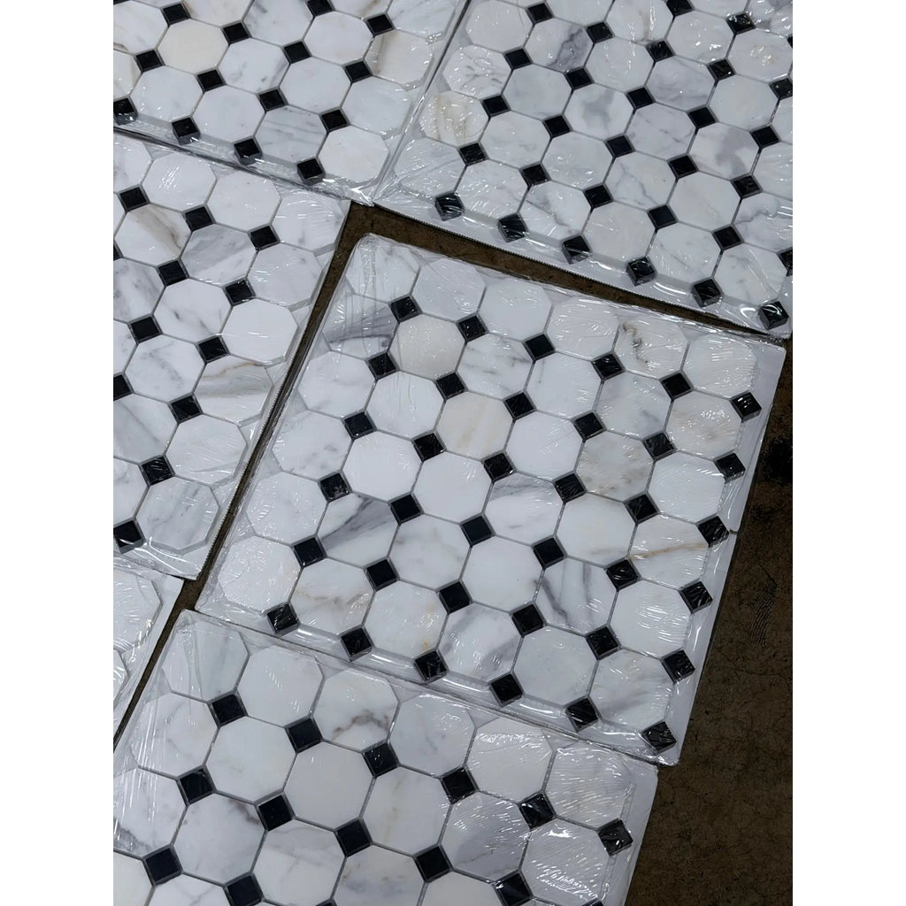 White marble hexagonal calacatta gold octagon mosaic tile with black diamond accents packaged in clear plastic