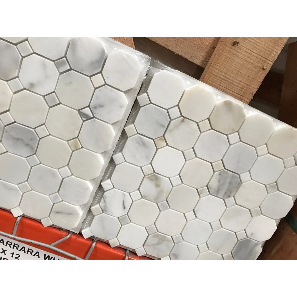 White marble mosaic tile with hexagonal pattern and subtle gray veining packaged in clear plastic for calacatta gold octagon design