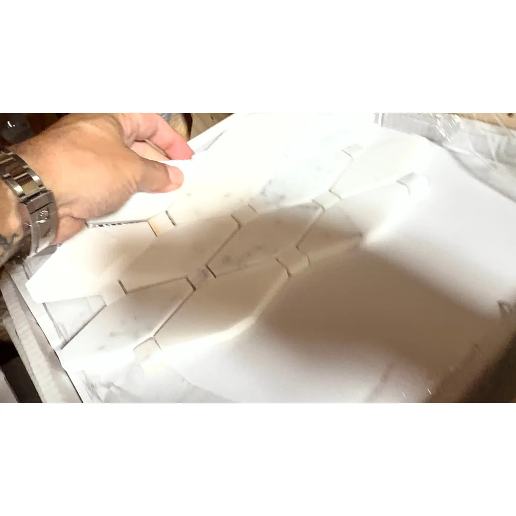 White geometrically patterned foam packaging for calacatta gold octave long octagon mosaic marble tile polished or honed