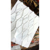 White marble Calacatta Gold octave long octagon mosaic tile with geometric hexagon and rectangular pattern wrapped in plastic