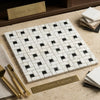White marble mosaic tile with black veined calacatta gold pinwheel pattern in polished or honed finish