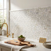 White italian marble calacatta gold subway tile backsplash with subtle gray veining in herringbone pattern polished