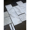 Calacatta Gold Stanza mosaic marble tile with white marble-effect and gray veining in showroom display