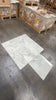 White marble-look rectangular tiles with gray veining from Calacatta Oliva Marble collection
