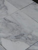 White marble-look floor tiles with grey veining from Calacatta Oliva Marble 12x24 collection