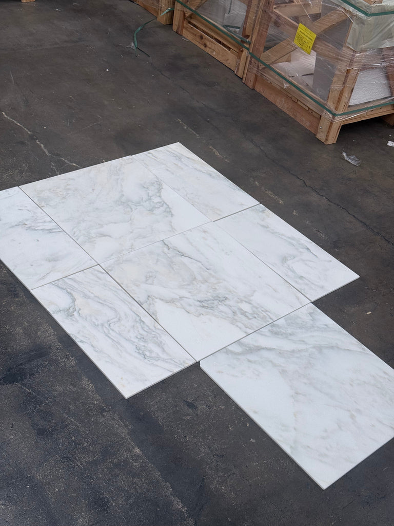 White marble-look porcelain tiles with grey veining from Calacatta Oliva Marble collection