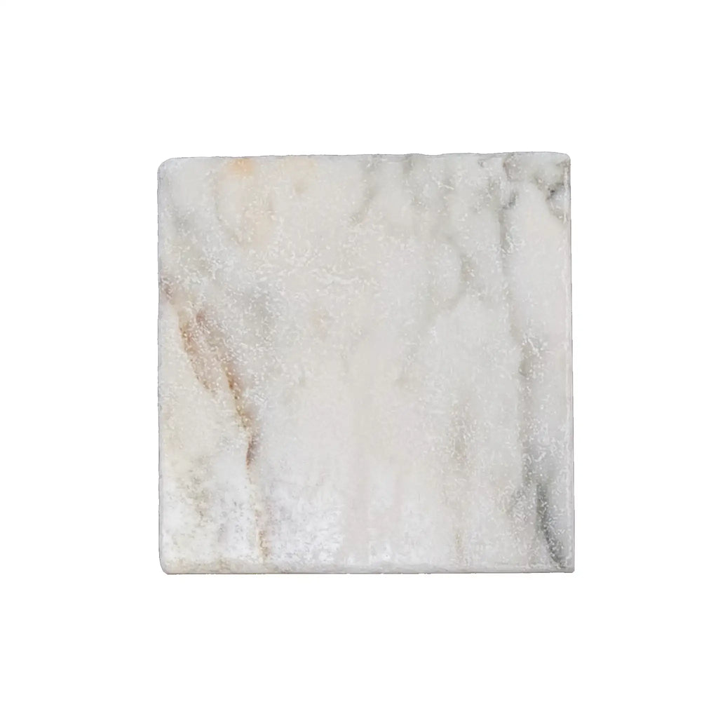 A square white calacatta verde royale marble 12x12 tile with subtle gray and beige veining and a tumbled finish