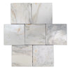 Calacatta verde royale marble 12x12 tumbled tile with white marble and subtle gray veining arranged in a cross pattern