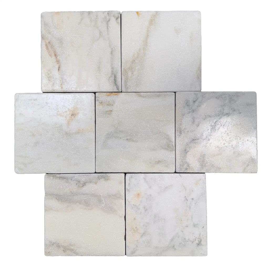 Calacatta verde royale marble 12x12 tumbled tile with white marble and subtle gray veining arranged in a cross pattern