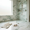 Calacatta verde royale marble 12x24 tile polished or honed used in a sleek green and white marble shower enclosure