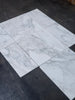 White marble-patterned ceramic tiles from Calacatta Oliva Marble 12X24 collection