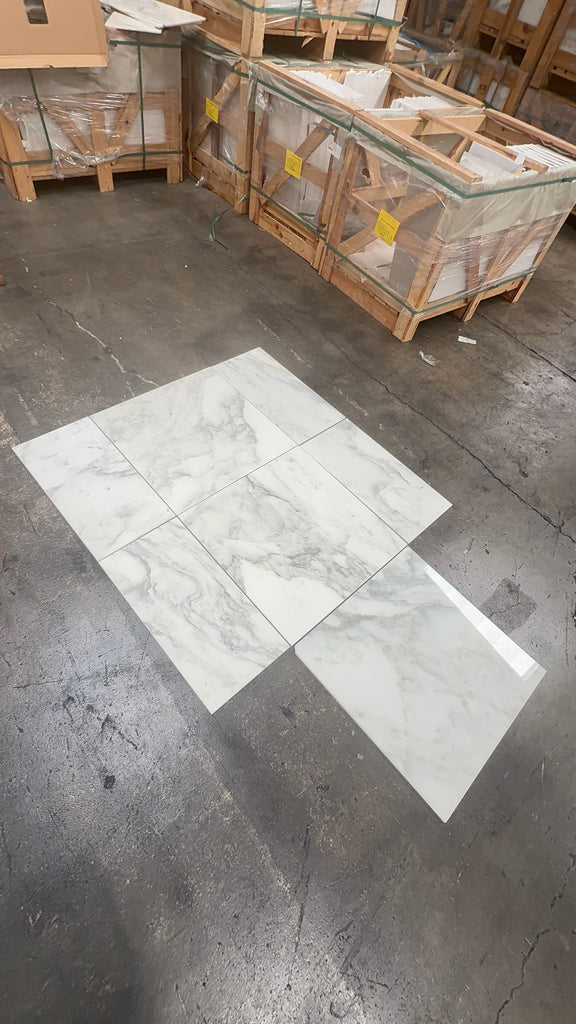White marble-patterned ceramic tiles from Calacatta Oliva Marble 12X24 collection