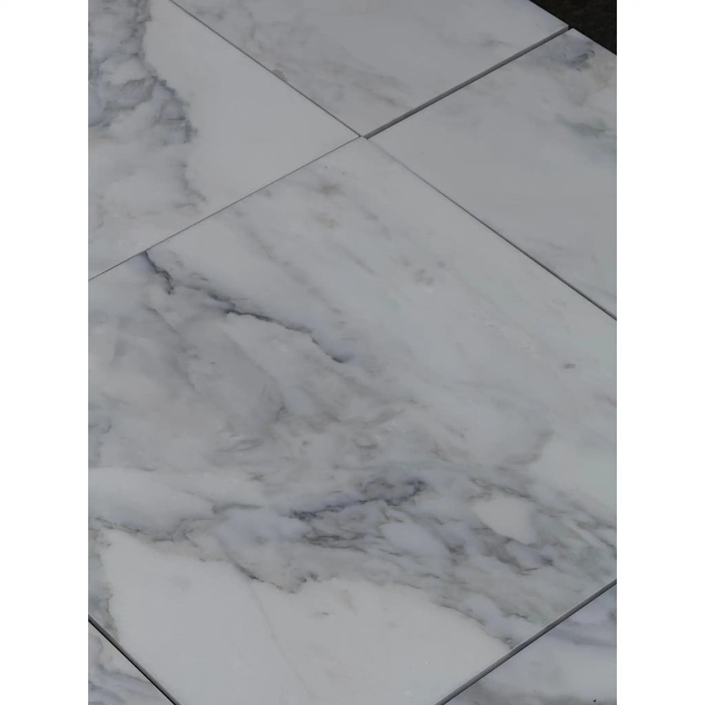 White marble-look floor tiles with grey veining from Calacatta Oliva Marble 12x24 collection