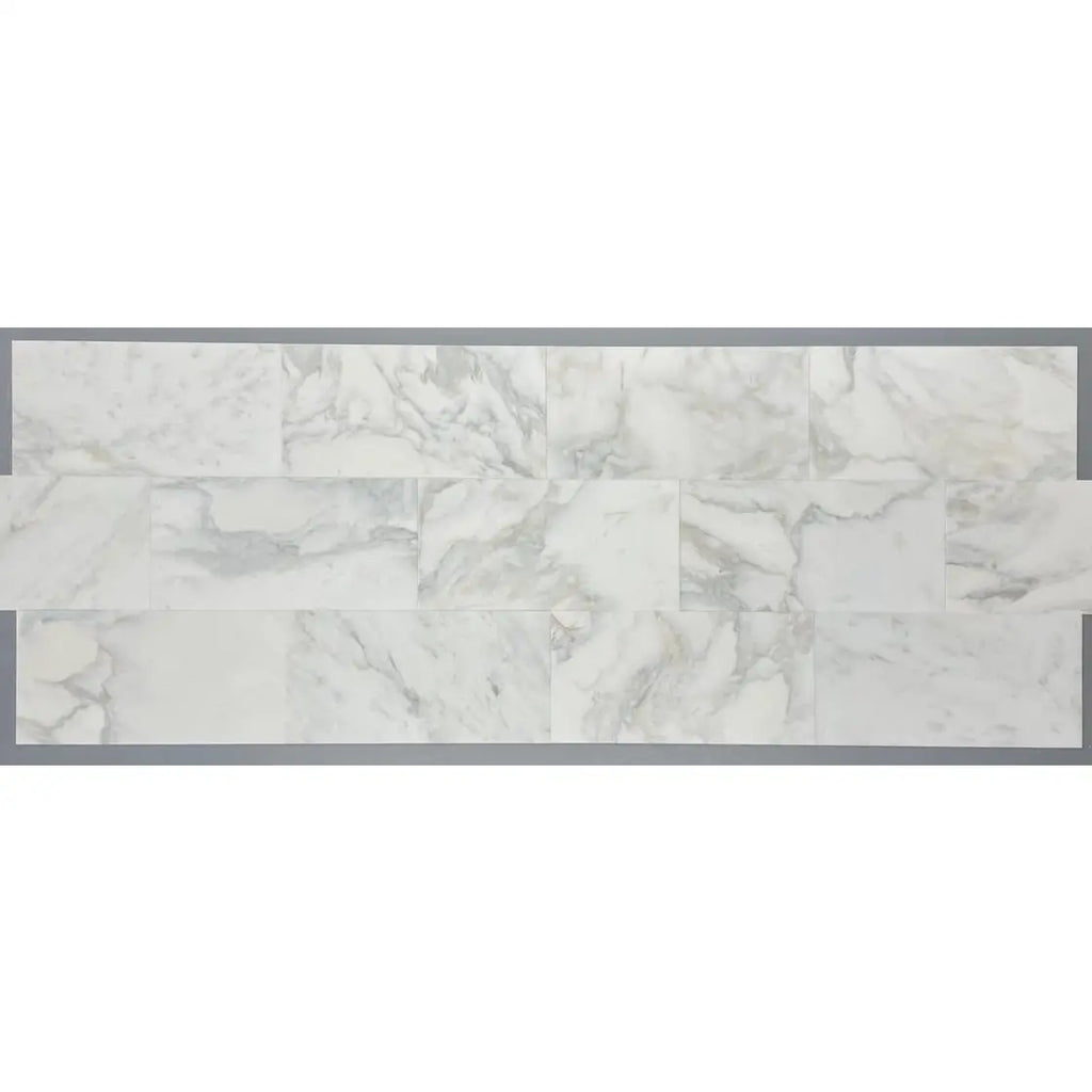 Calacatta Oliva Marble 18x36 tile with white marble subway style backsplash and grey veining