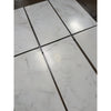 Calacatta Oliva marble 18x36 tile with white marble and black grout
