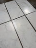 Calacatta Oliva marble 18x36 tile with white marble and black grout