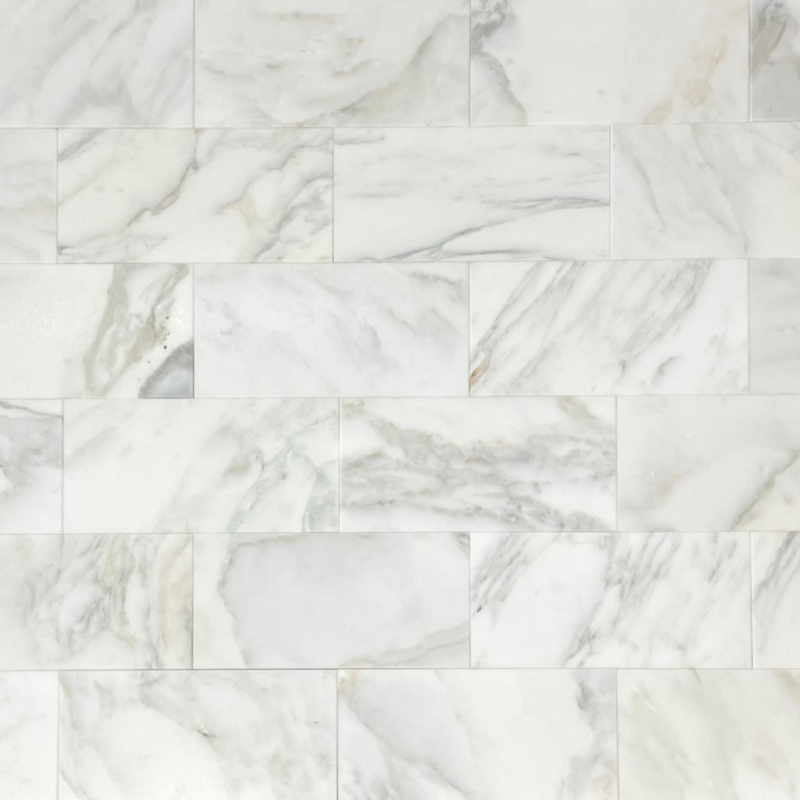 Calacatta Oliva Marble 18X36 tile with white marble, gray, and gold veining