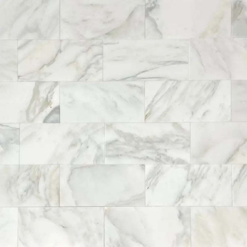 Calacatta Oliva Marble 18X36 tile with white marble, gray, and gold veining