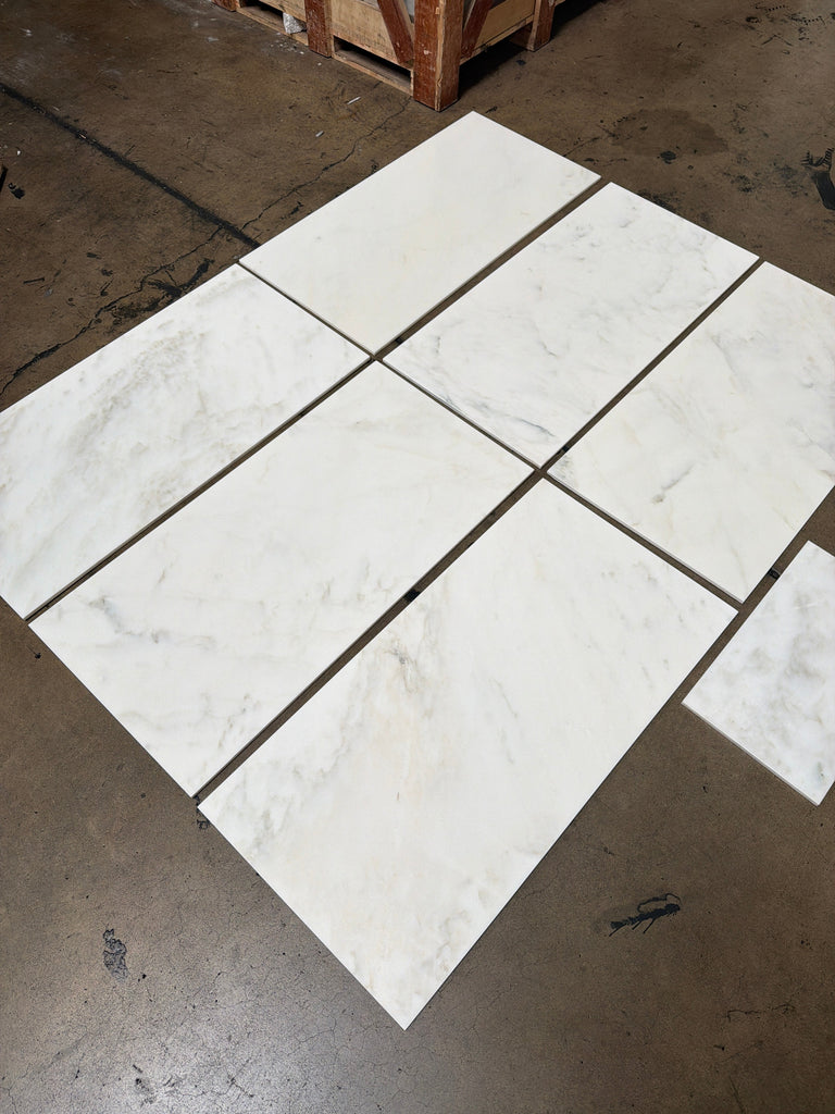 Polished Calacatta Oliva marble tile with white base and gray veining, 18x36 size