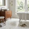 White clawfoot bathtub with towel beside calacatta verde royale marble 2 inch hexagon mosaic tile polished or honed