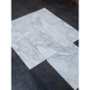 Arrangement of rectangular Calacatta Oliva Marble 24x24 tiles with gray veining