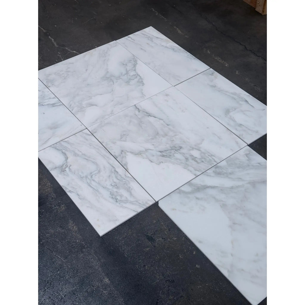 Arrangement of rectangular Calacatta Oliva Marble 24x24 tiles with gray veining