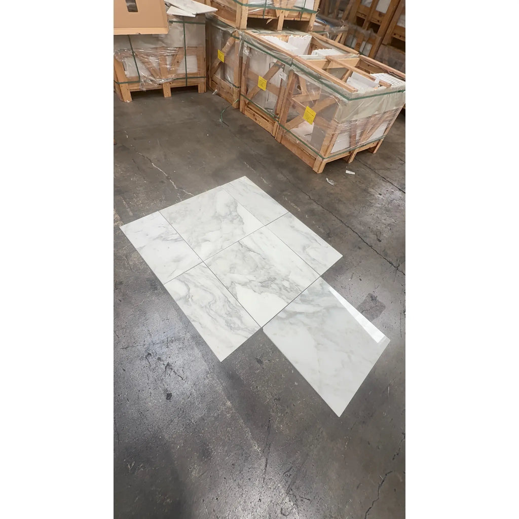 White marble-patterned ceramic floor tiles from Calacatta Oliva Marble 24X24 collection