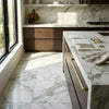 White marble calacatta verde royale 24x24 tile with elegant gray veining and gold-toned drawer pulls on countertop