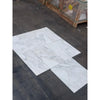 White marble-look porcelain tiles with gray veining in Calacatta Oliva Marble 24x24 style