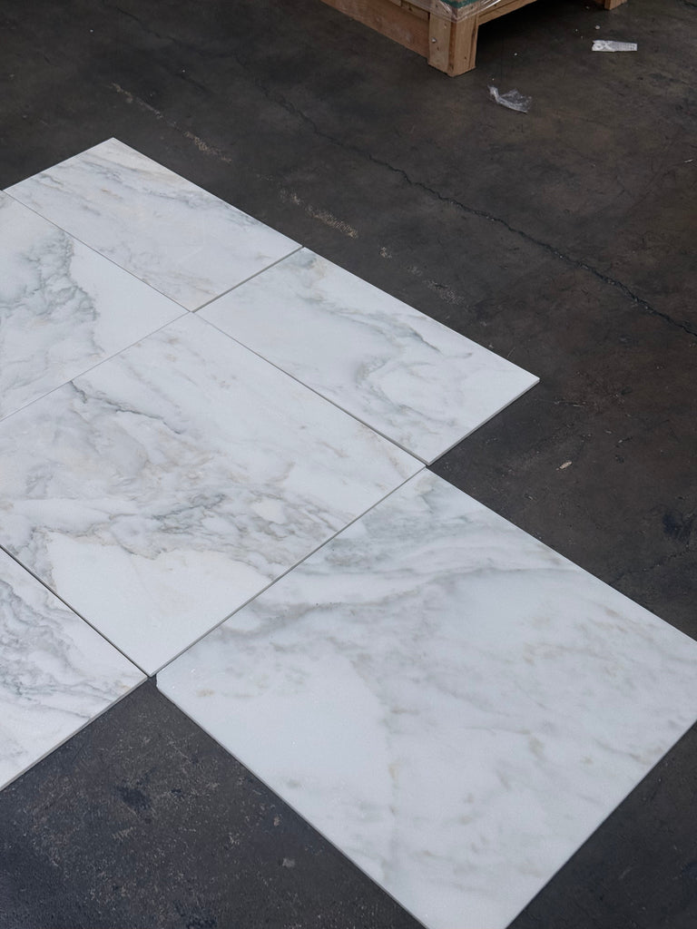 White marble tiles with gray veining from Calacatta Oliva Marble 24X24 collection