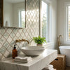 White ceramic bowl sink with smooth rounded design and glossy finish displayed with calacatta verde royale marble 3 inch arabesque mosaic tile