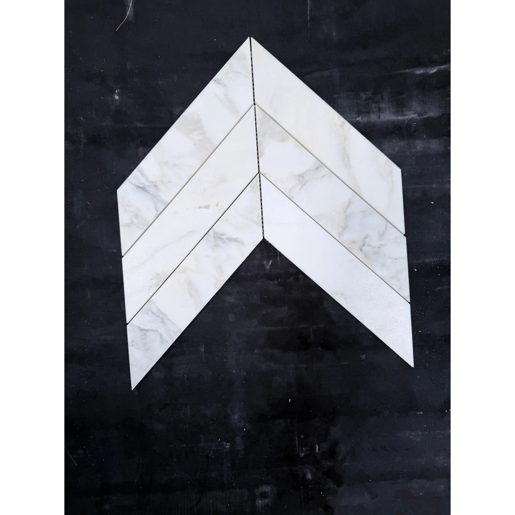 White marble calacatta verde royale 3x12 tiles arranged in a polished-honed chevron mosaic pattern