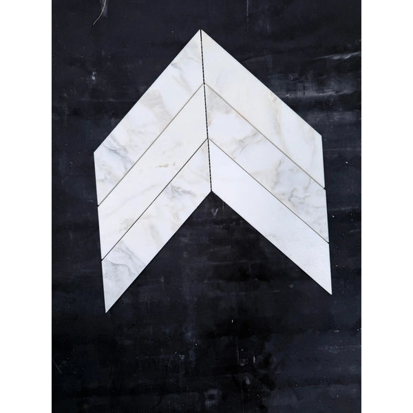 White marble calacatta verde royale 3x12 tiles arranged in a polished-honed chevron mosaic pattern